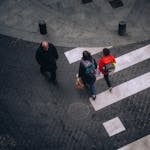 High-angle view of people crossing a street in Bilbao, Spain, showcasing urban life.